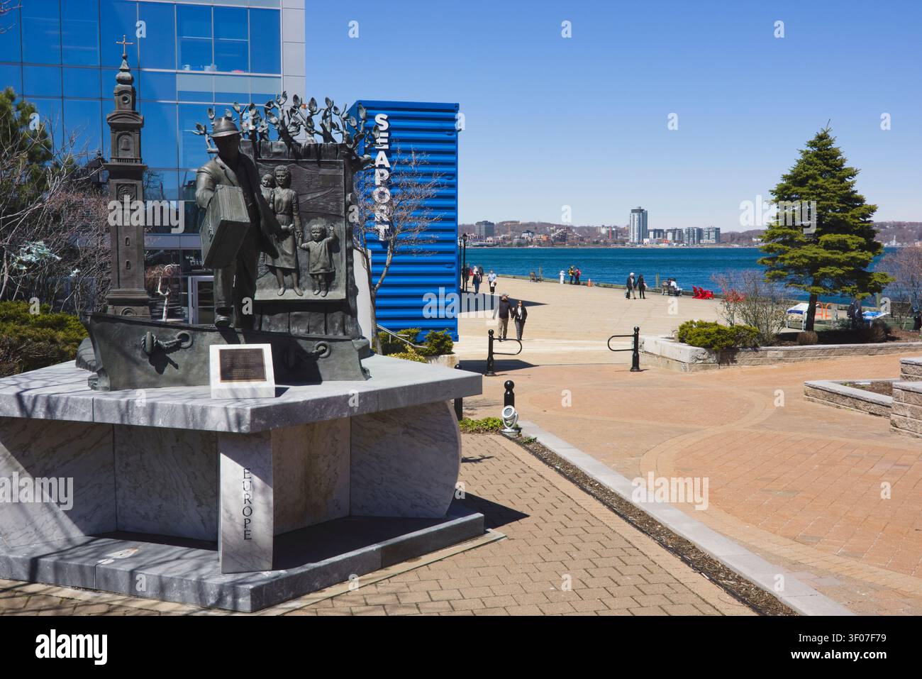 La statua in bronzo "The Emigrant" che onora gli immigrati, situata vicino al Pier 21 lungo il distretto portuale di Halifax. Foto Stock