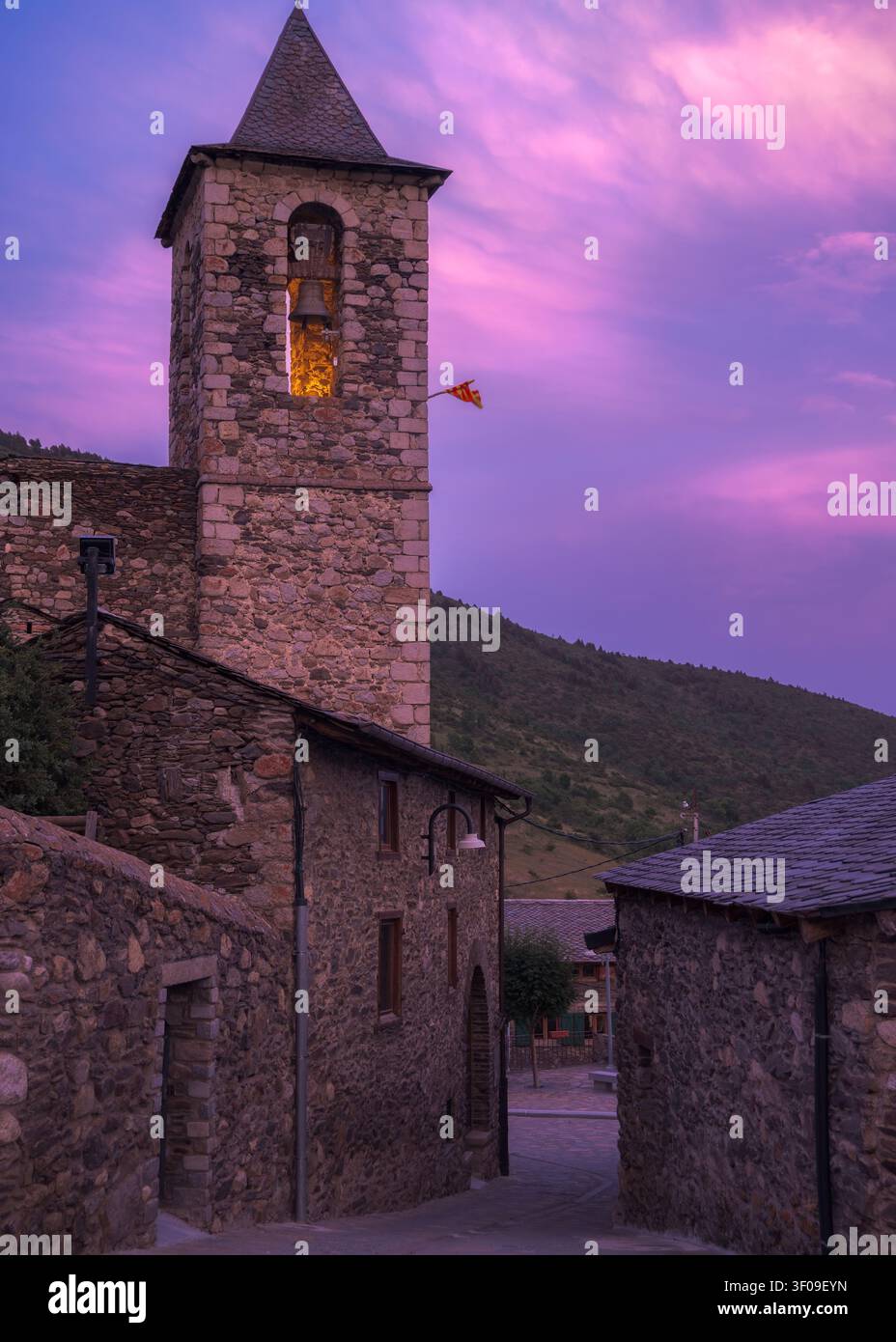 Incastonata a Meranges, la chiesa romanica di Sant Sadurni dell'XI secolo risplende caldamente al tramonto, mostrando il suo antico fascino di pietra, Catalogna Foto Stock