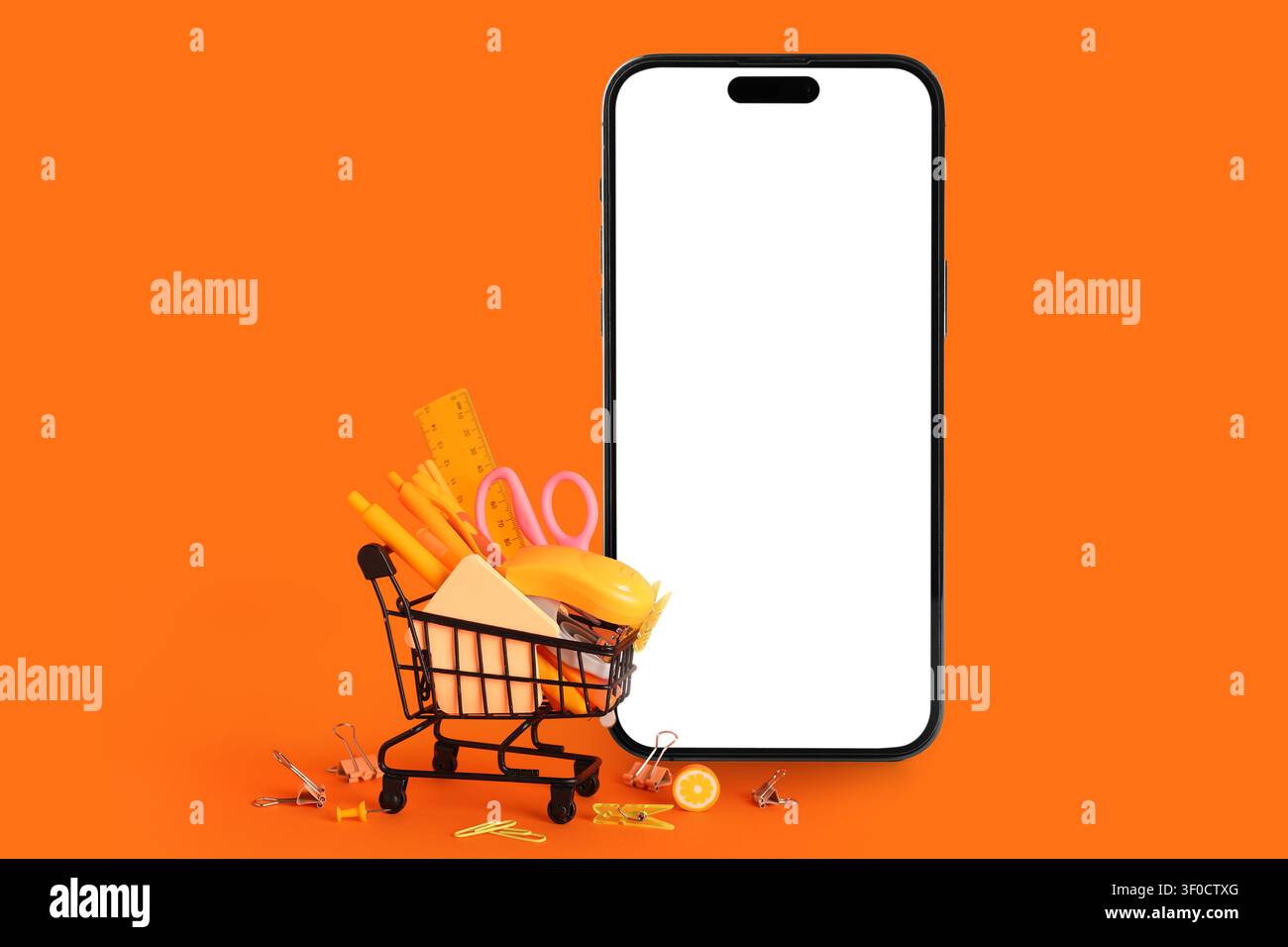 Smartphone con schermo vuoto e carrello riempito di forniture per ufficio arancioni Foto Stock
