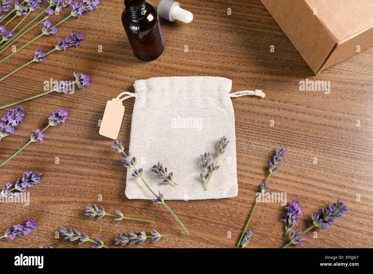 Set cosmetico biologico lavanda fatto a mano con borsa in bustina naturale su legno. Accogliente confezione regalo per il benessere della casa con prodotti aromaterapici sullo sfondo della presentazione Foto Stock