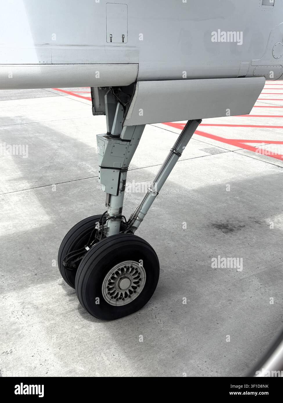 Treno di atterraggio con doppio pneumatico visto dalla finestra di un aereo regionale turboalettone mentre si prepara al decollo. Foto Stock