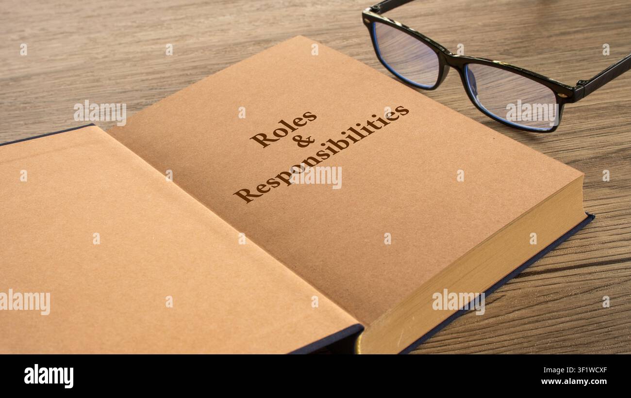 Ruoli e responsabilità pagina di libro aperta con occhiali Foto Stock