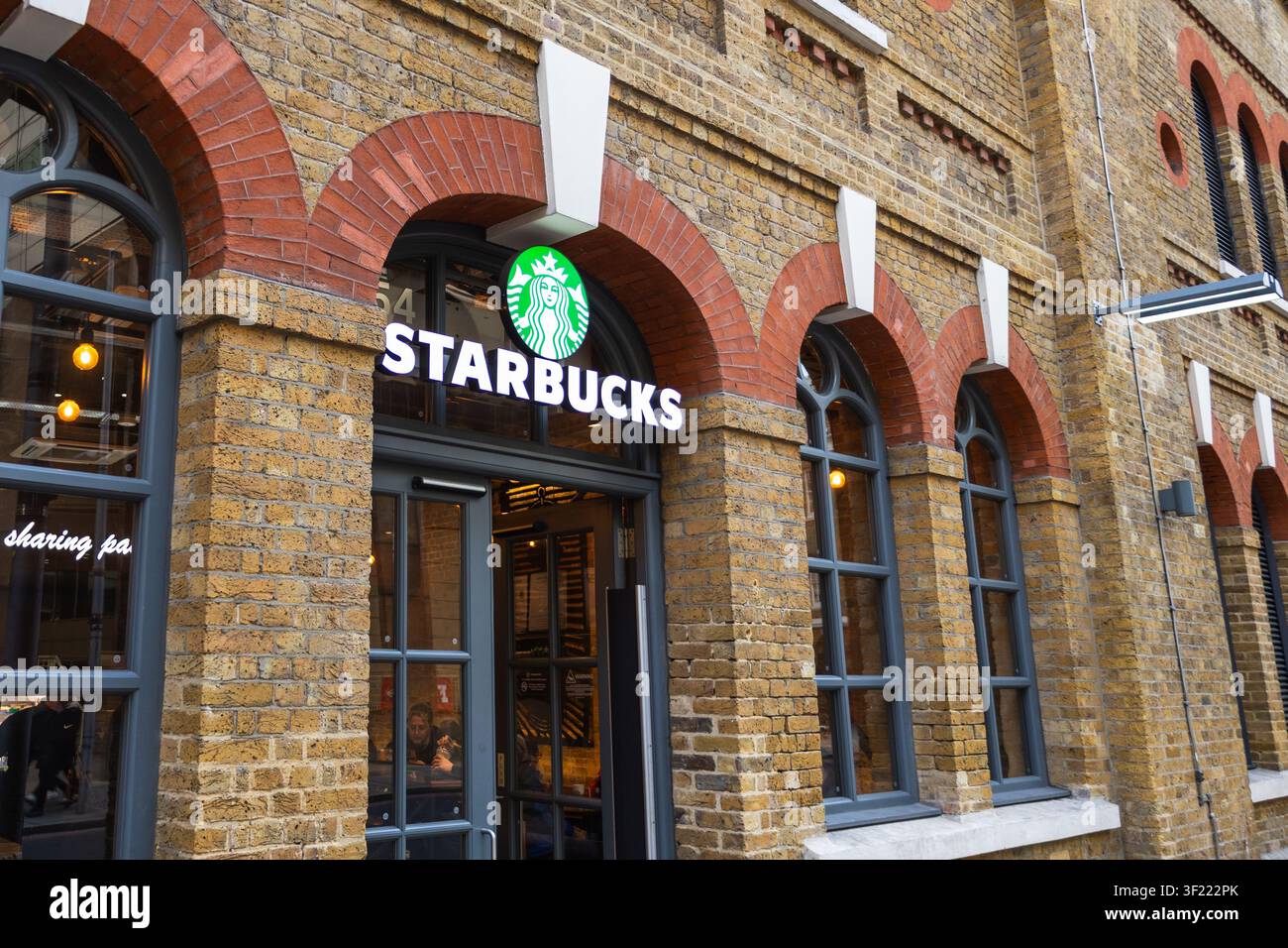 Facciata del caffè Starbucks in un edificio storico in mattoni. Londra, Regno Unito, 14 gennaio 2024 Foto Stock