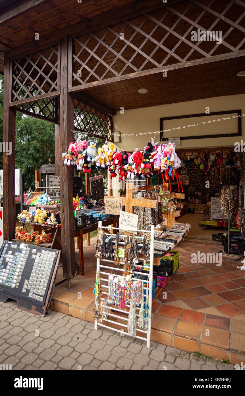 Un vivace banco di mercato di strada che espone una varietà di souvenir turistici, gioielli, giocattoli e oggettini colorati Foto Stock