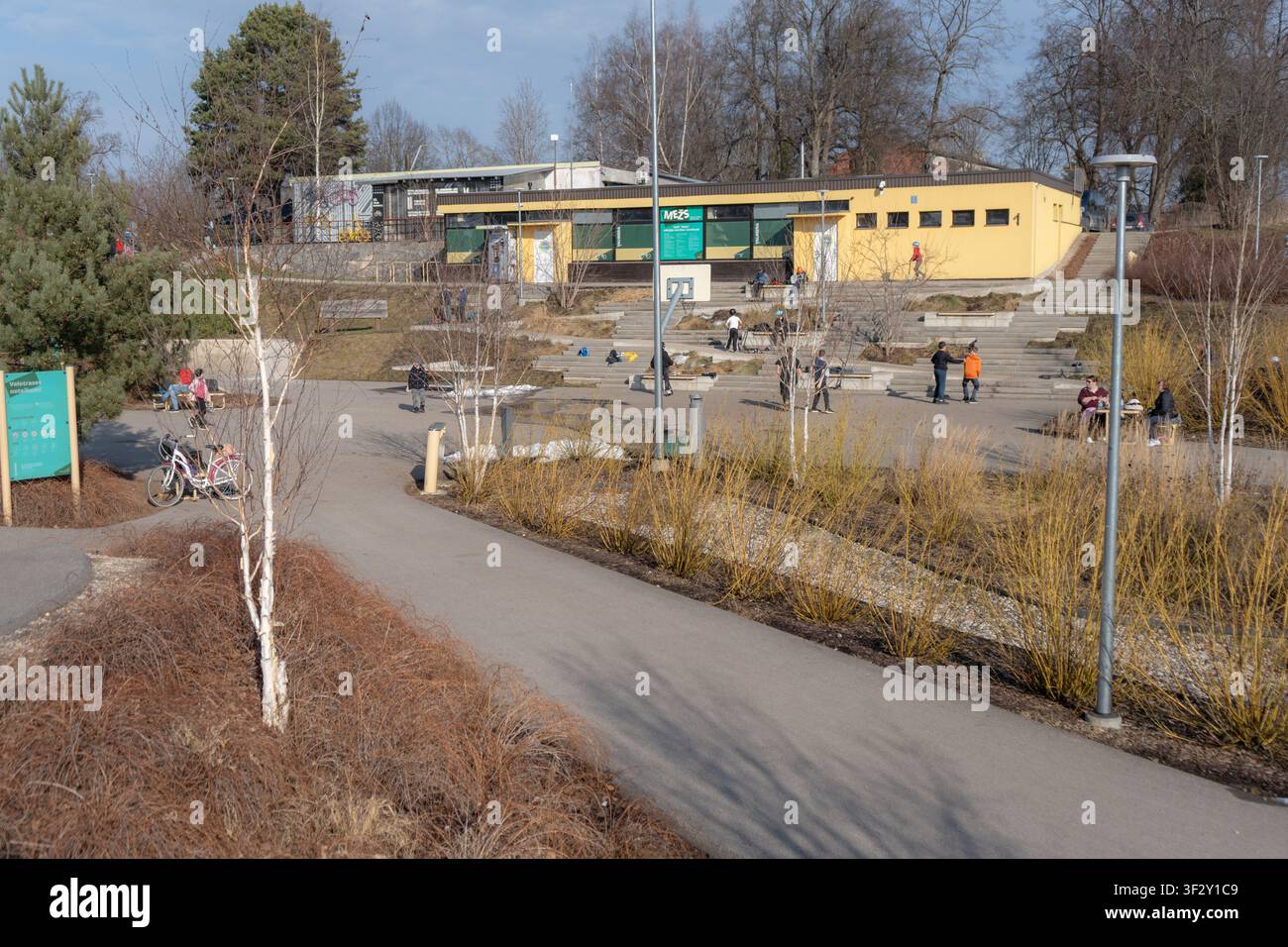 Bambini e adolescenti che trascorrono il pomeriggio delle vacanze scolastiche in un parco pump track urbano in primavera il 09.03.2026. Valmiera. Lettonia Foto Stock