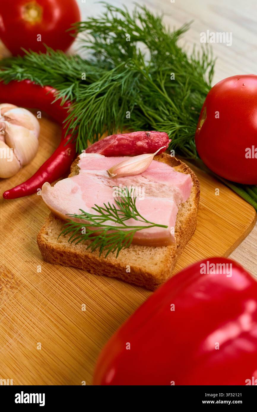 fotografia ravvicinata autentica che cattura un panino saporito con lardo affumicato, aneto fresco e aglio, perfetto per progetti culinari focalizzati sulla tradizione slava Foto Stock