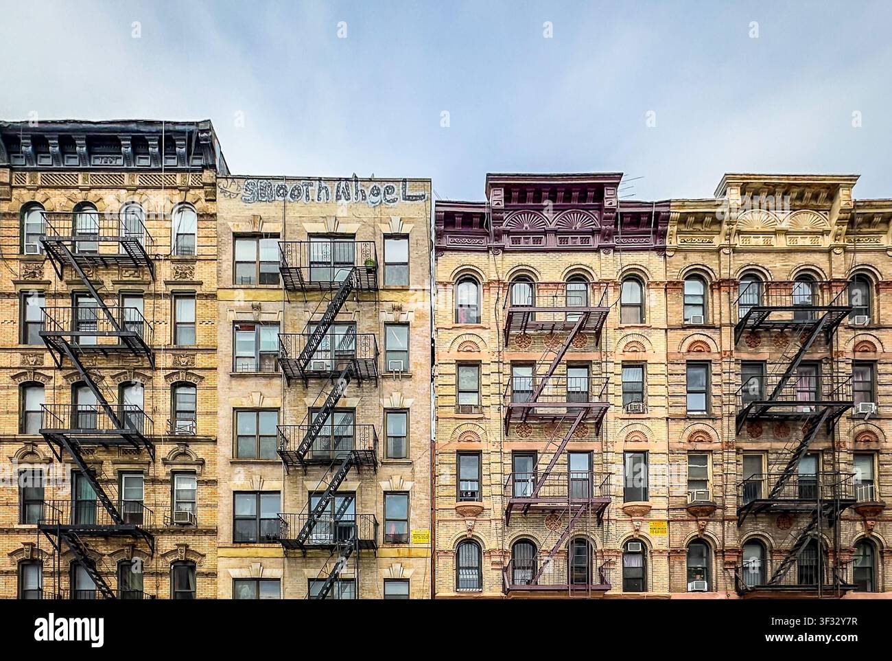 New York City, USA, 30 aprile 2024, edificio in mattoni con scala antincendio metallica esterna situata su Henry Street Foto Stock
