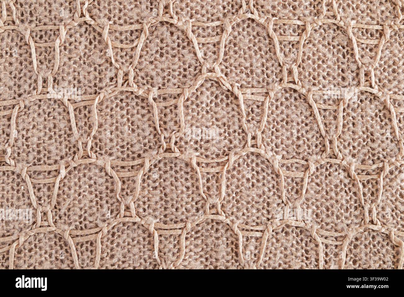 Maglia di iuta intrecciata beige con motivo a nido d'ape in macramé e texture di corda naturale per l'arredamento Foto Stock