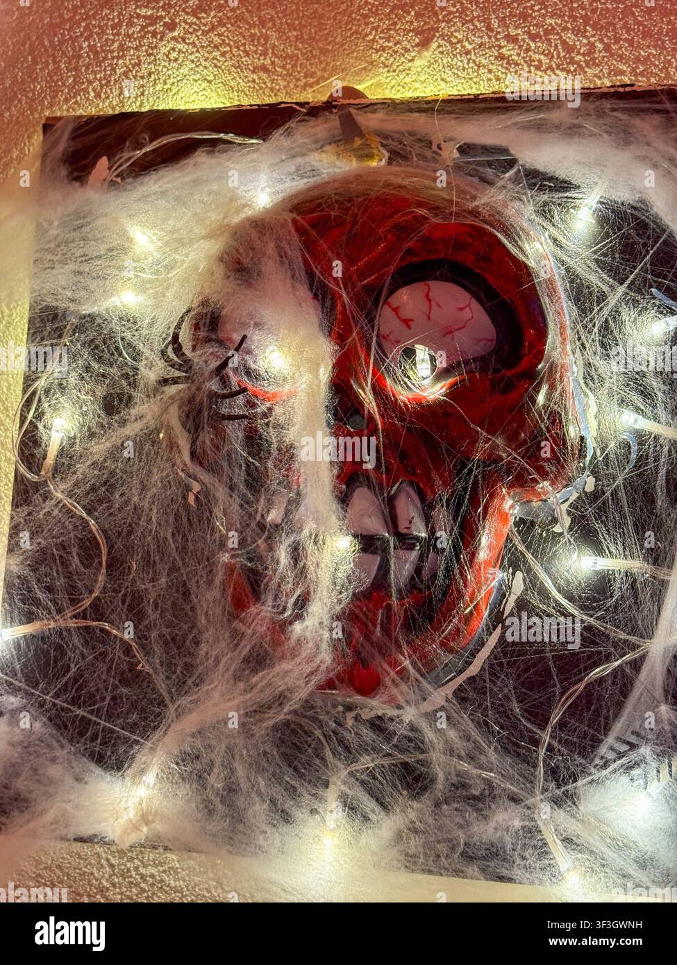 maschera di teschio zombie rossa, ragnatele, luci, decorazione spettrale di Halloween, spazio per banner, concetto di Halloween, orrore Foto Stock