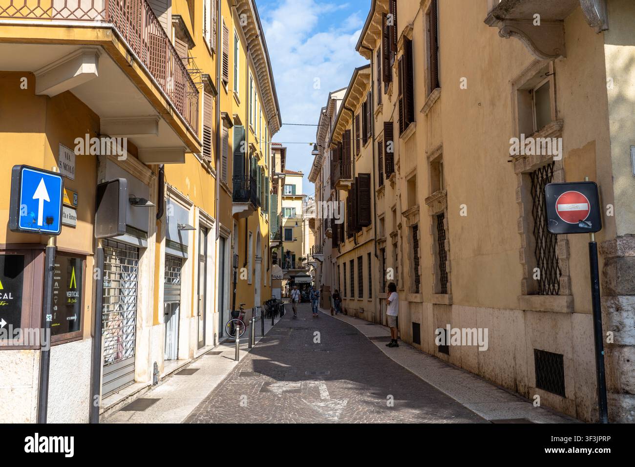 Verona Italia - 1 settembre 2025: Una strada stretta a Verona Italia con pedoni che camminano lungo la strada Foto Stock