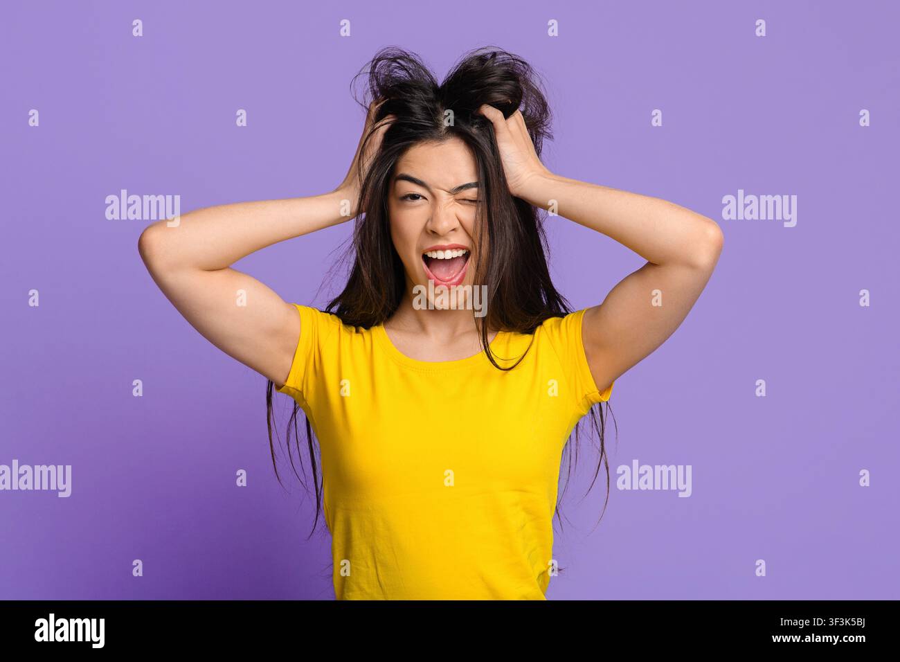 Umore MAD. Crazy Asian Woman che tocca i capelli e l'inzidire alla macchina fotografica Foto Stock