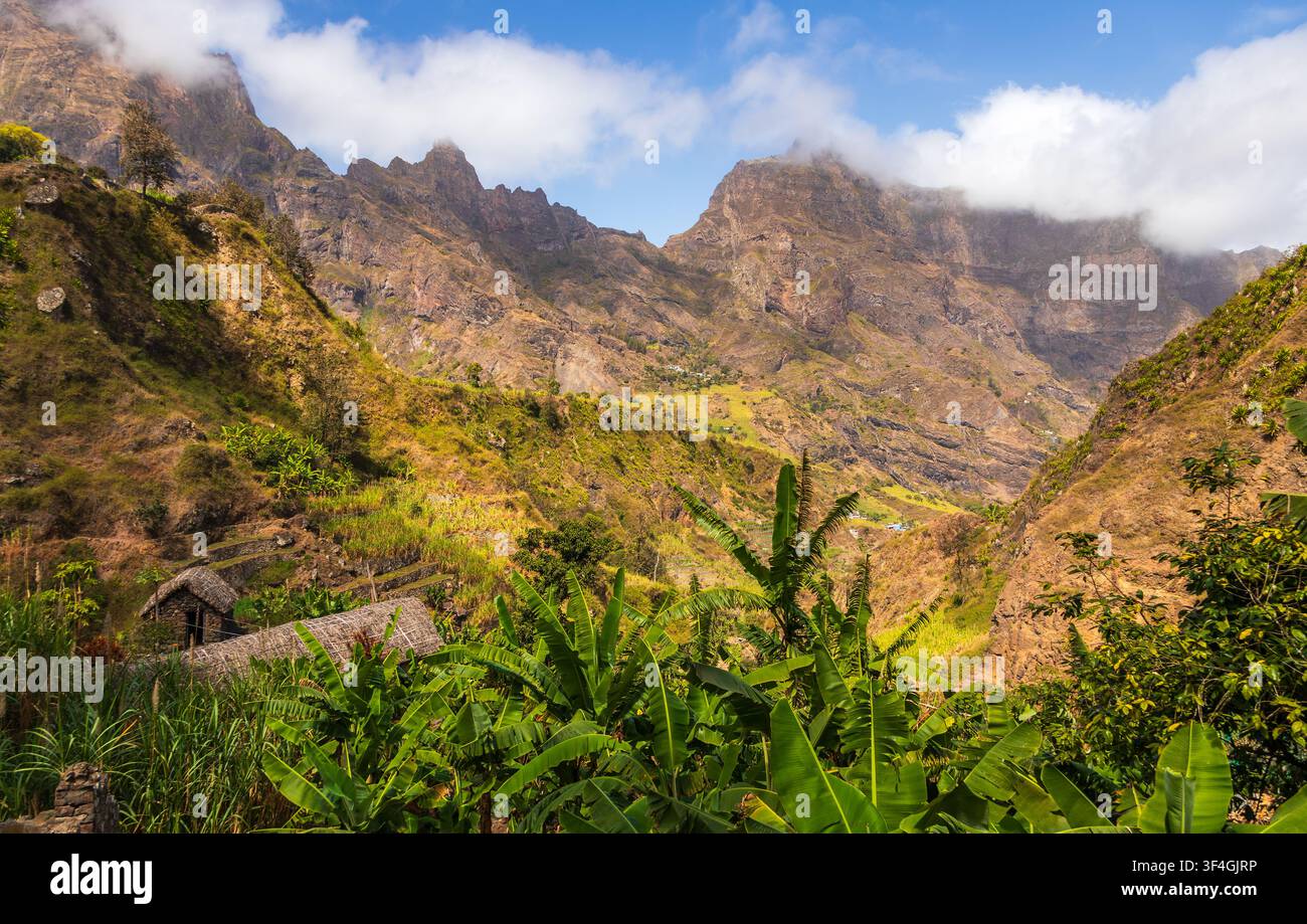 Vista aerea della Trilha do Vale do Paul che si snoda attraverso montagne verdi e lussureggianti, piantagioni di banane e case in pietra tradizionali a Faja de Cima, Paul, Ca Foto Stock