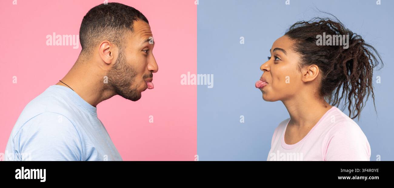 Uomo e donna che si fanno facce buffe a vicenda, sfondo rosa e blu Foto Stock