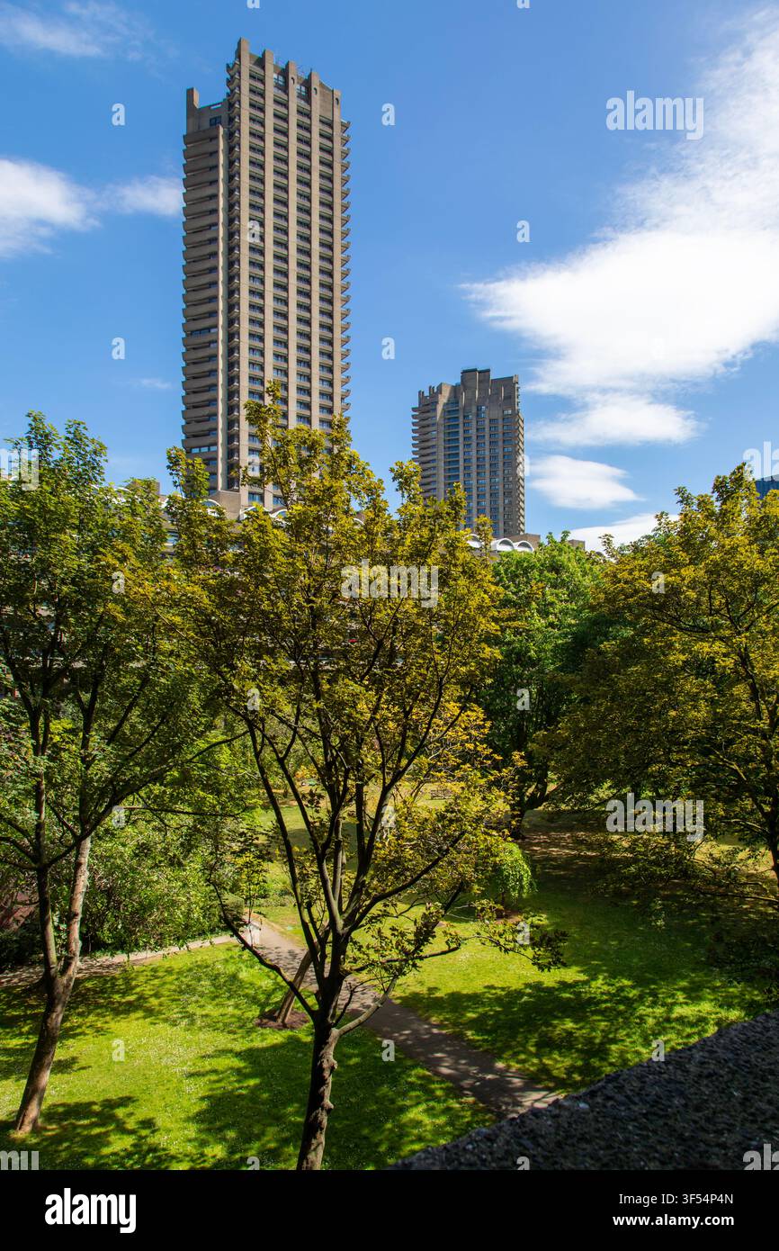 Le torri di Barbican incombono su un giardino segreto nella City di Londra, Inghilterra Foto Stock