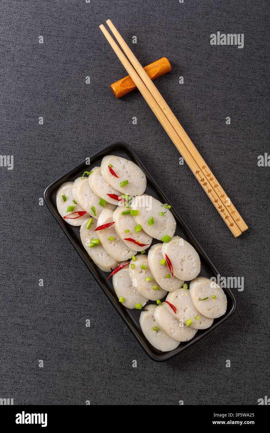 Salsicce di pollo con uova di pesce volante cotte su tagliere di legno Foto Stock