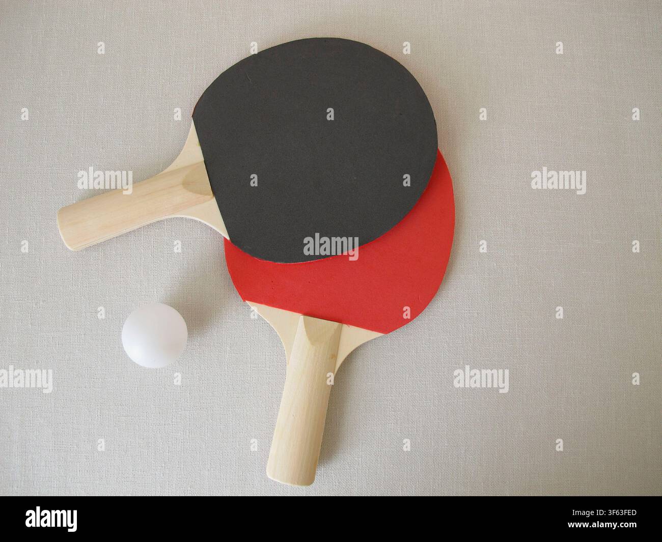 Due racchette da ping pong per principianti e una palla da tennis Foto Stock