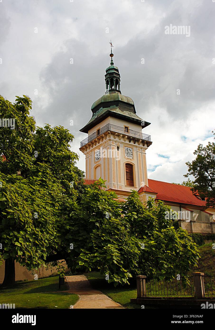Benatky nad Jizerou, Regione della Boemia centrale, Repubblica ceca: torre dell'orologio rinascimentale del castello di Benatky che si erge sopra alberi rigogliosi Foto Stock
