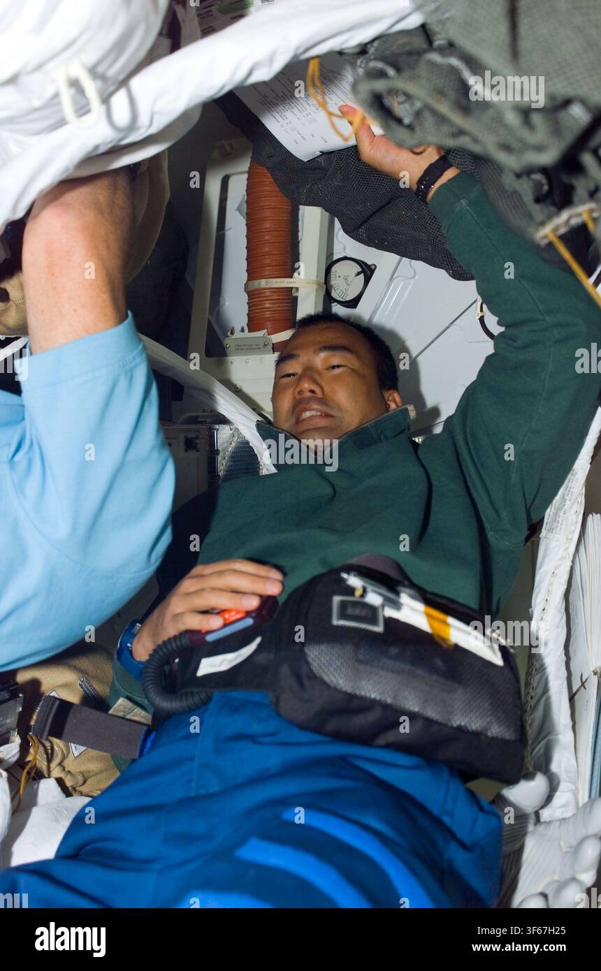 Soichi Noguchi, astronauta giapponese e specialista di missione sulla STS-114, con un'Unità di Mobilità Extraveicolare (EMU) sul ponte intermedio, durante il programma dello Space Shuttle. Foto Stock