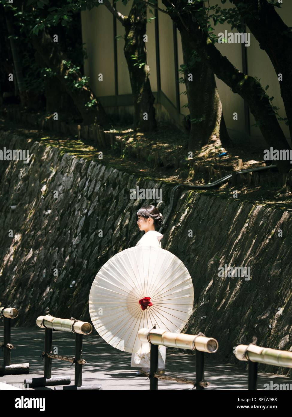 Donna in kimono bianco che tiene un ombrello tradizionale giapponese di carta a Higashiyama, Kyoto, Giappone Foto Stock