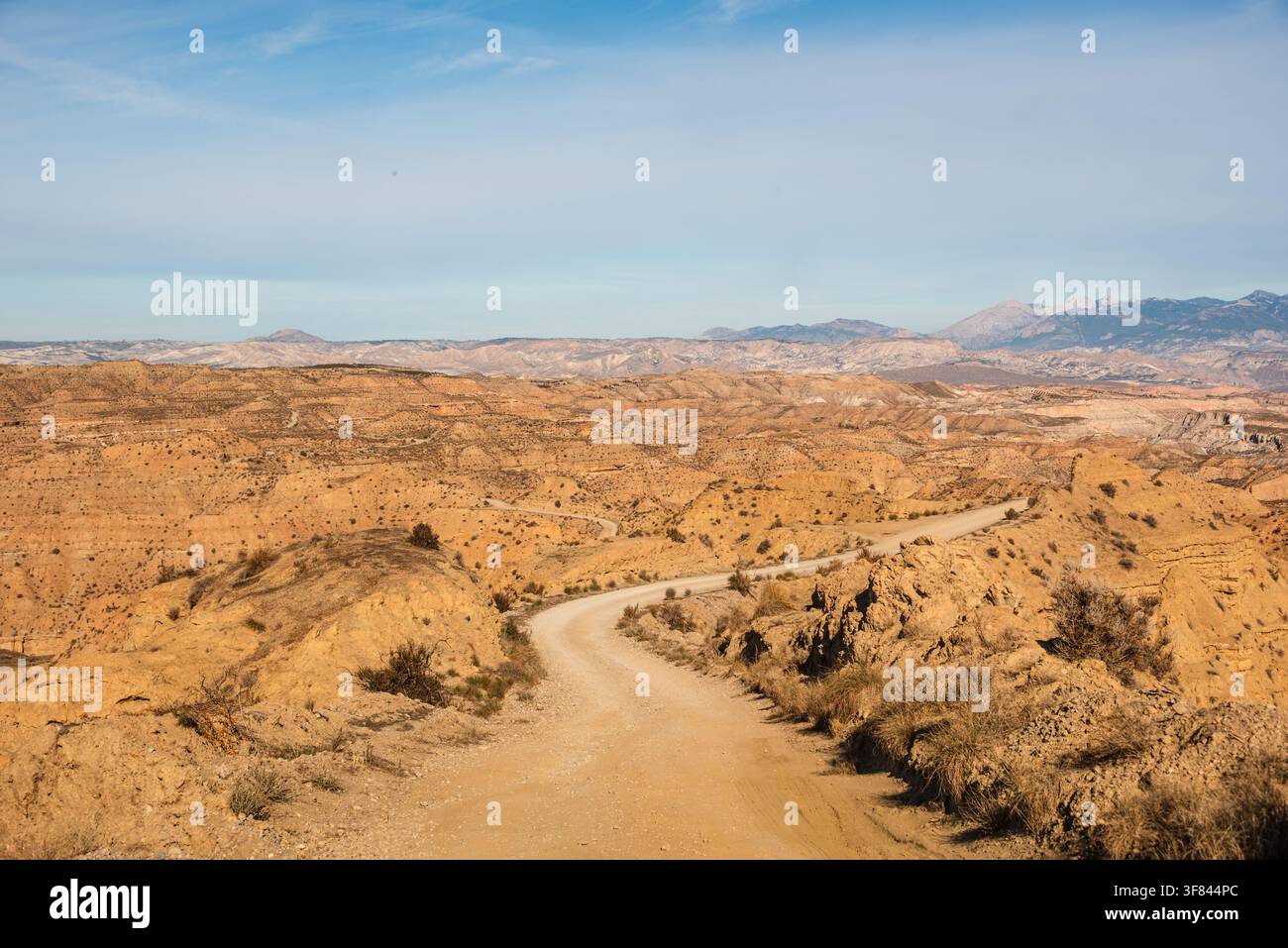Strada sterrata che si inoltra nei badland erosi del deserto di Gorafe nel nordest di Granada, Spagna Foto Stock