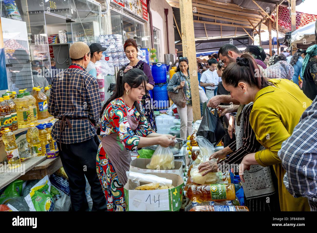 Mercato alimentare affollato con venditori e acquirenti a Khiva, Uzbekistan, che mostra prodotti locali e frutta e verdura fresca Foto Stock