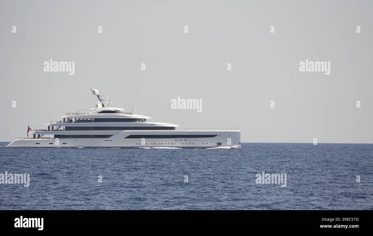 Elegante yacht di lusso che naviga sul mare aperto sotto un cielo sereno, mostrando un design elegante. Sud della Francia, Mar Mediterraneo Foto Stock