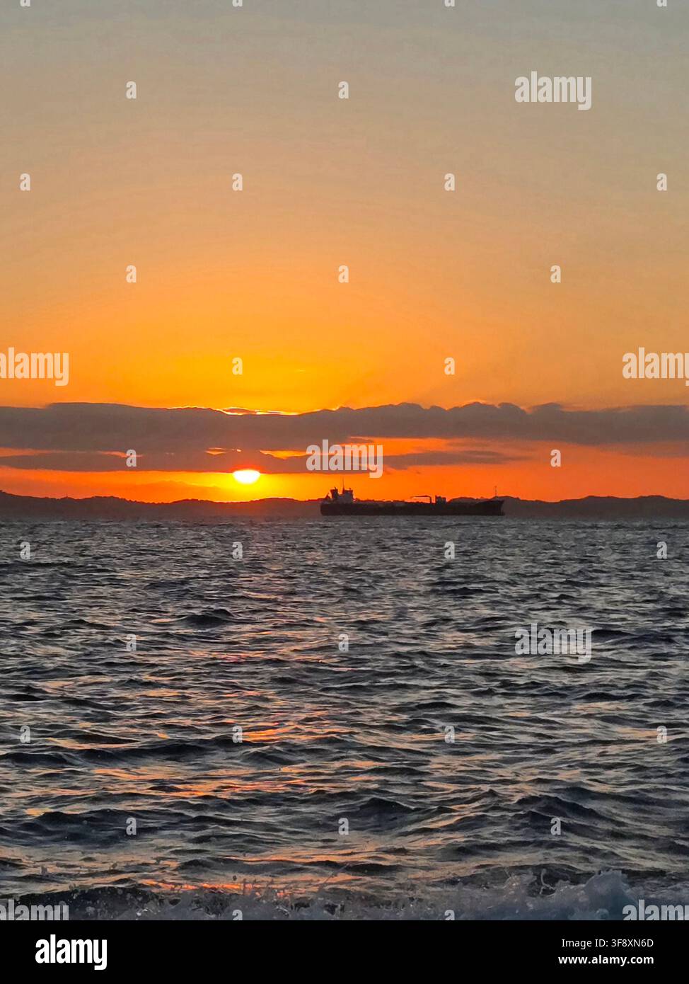 Silhouette di una nave da carico al tramonto nella Baia di Tutti i Santi, Bahia, Brasile - Immagine stock catturata con smartphone