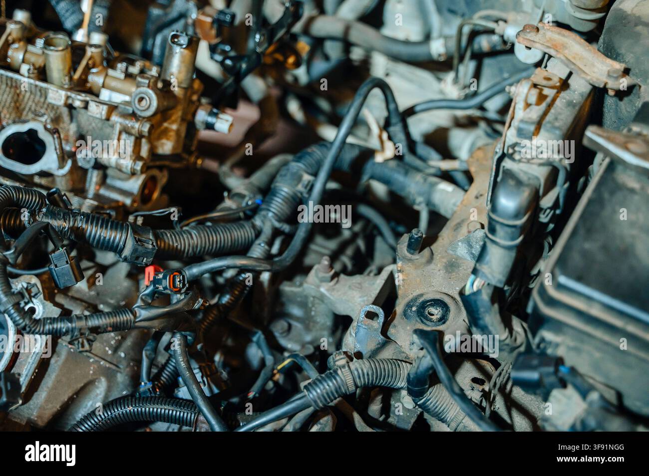 Primo piano dettagliato dei componenti moderni del motore dell'auto con cavi, tubi e parti tecniche sotto il cofano aperto, riparazione auto. Foto di alta qualità Foto Stock