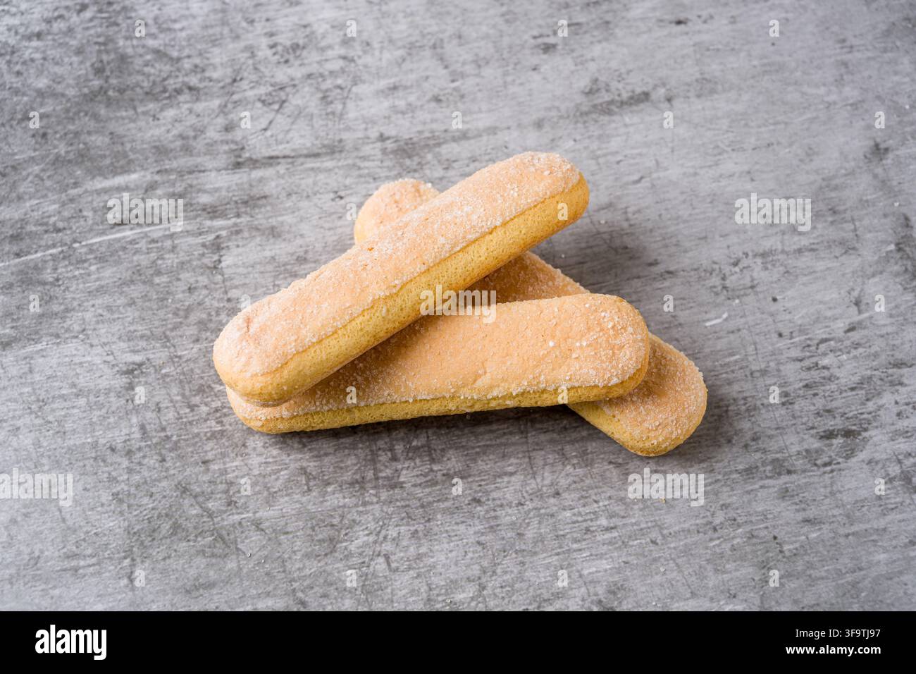Biscotti Savoiardi a forma di cucchiaio impilati, tradizionalmente usati per preparare il tiramisù Foto Stock