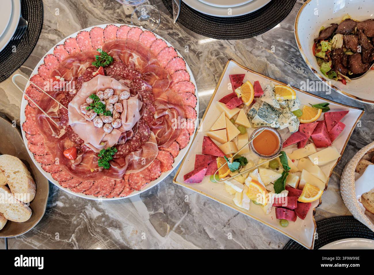 Piatti di tapas molto colorati di salumi con formaggio e carni affumicate. Foto Stock