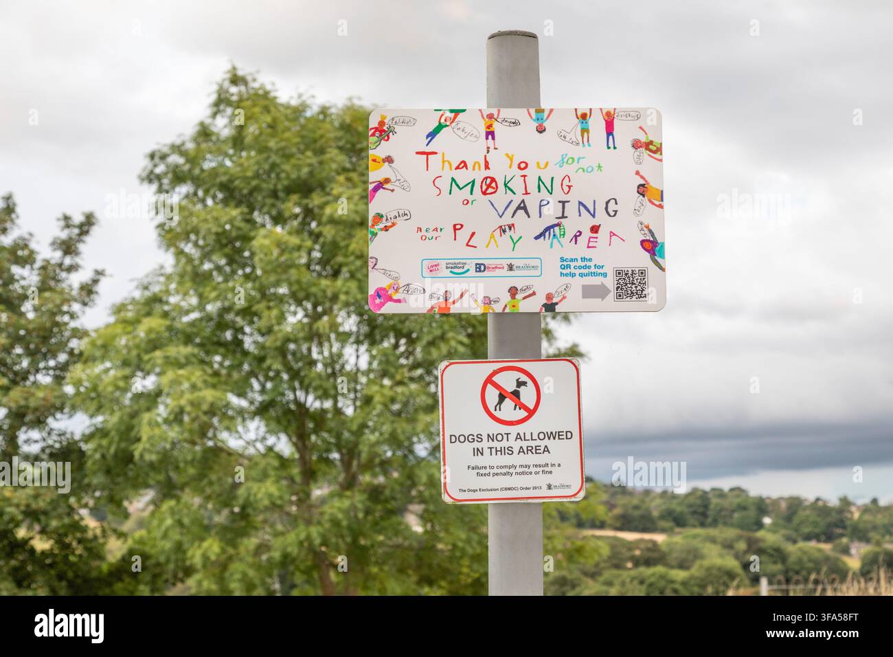 Segnale "Divieto di fumare o vaporizzare" e "Cani non ammessi" in un parco giochi per bambini, Oakworth, Yorkshire. Foto Stock