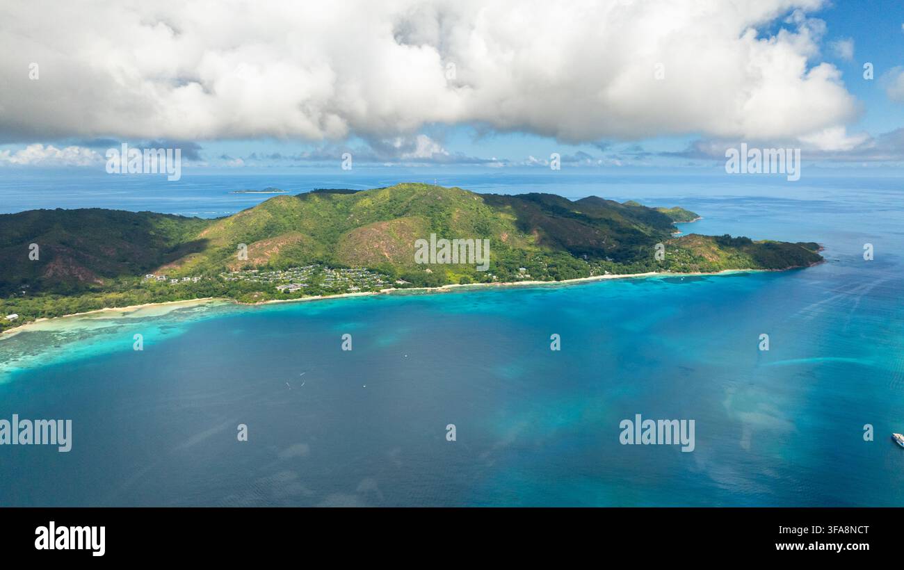 Vegetazione lussureggiante e affioramenti rocciosi coprono l'isola, con spiagge di sabbia bianca e acque turchesi vibranti lungo la costa. Curieuse, Seychelles. Foto Stock