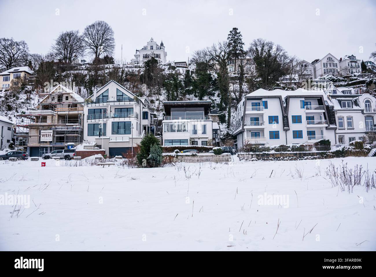 Eleganti case sulle colline coperte di neve durante un raro clima invernale lungo il fiume Elba Foto Stock
