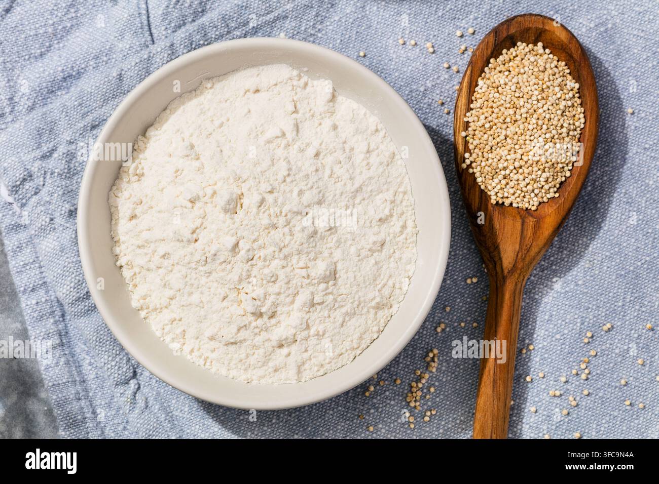 Farina di quinoa cruda biologica sana macinata in una ciotola Foto Stock