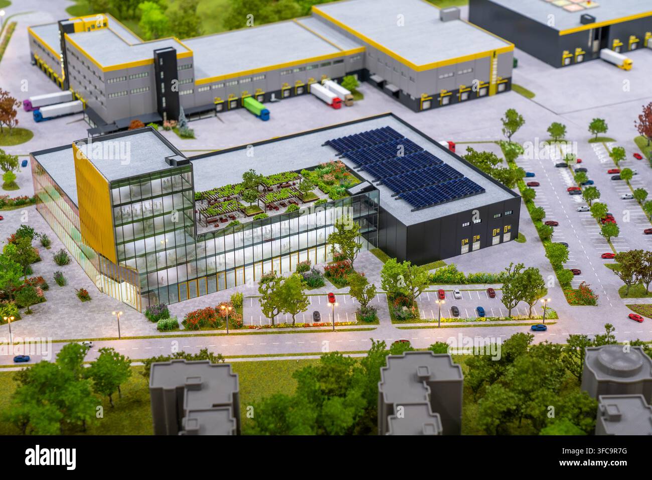 Modello di presentazione in plastica che mostra un parco industriale sostenibile con edifici commerciali, strutture logistiche, pannelli solari, giardino sul tetto e strade Foto Stock