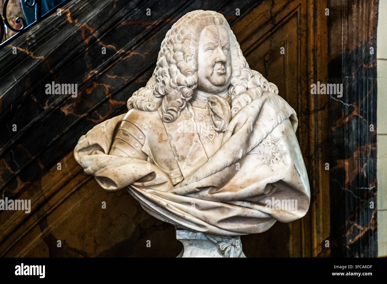Un busto in marmo di Stanislas Leszczynski, opera dello scultore René-Michel Slodtz, si trova nella scala di un edificio storico vicino a Place Vaudémont a Nancy, Grand Est, Francia. Un rivestimento in marmo venato forma lo sfondo della nicchia. Foto Stock