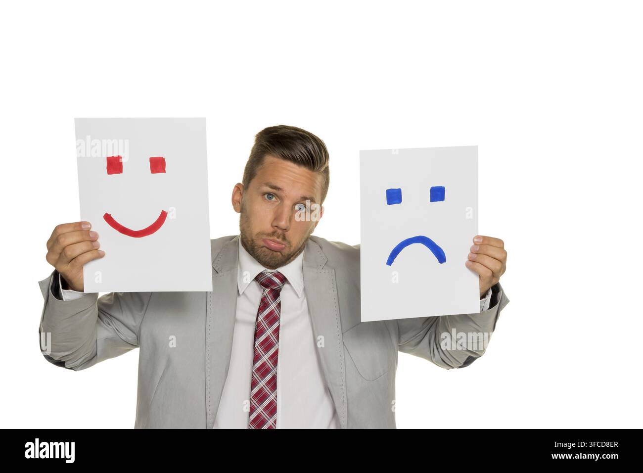 Un manager o un imprenditore non riesce a decidere se piangere o ridere Foto Stock