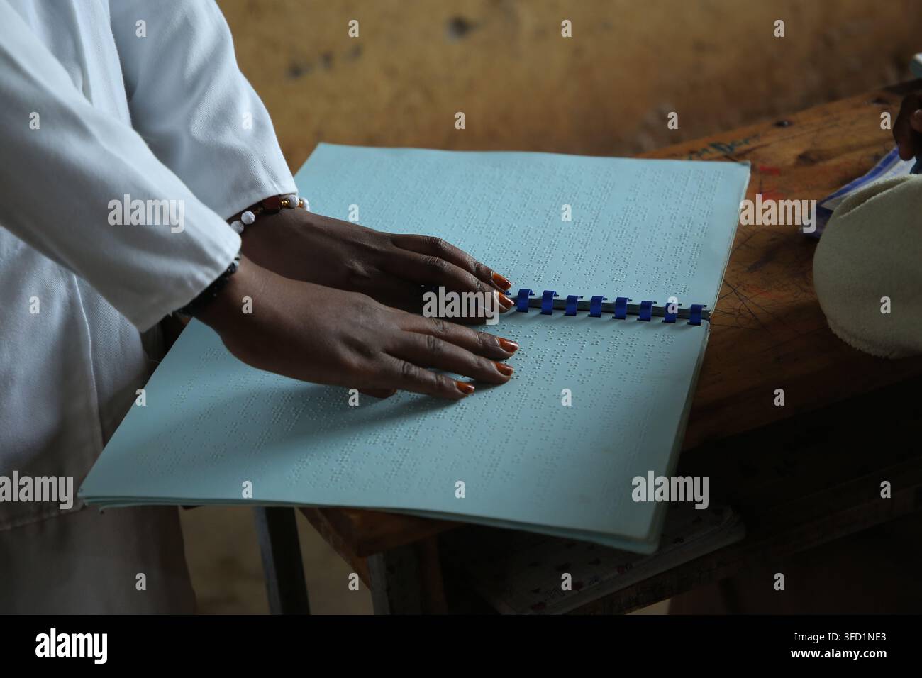 Kigali, Ruanda – 17 maggio 2023. Un insegnante non vedente utilizza il braille, un sistema di scrittura tattile composto da punti in rilievo che permette a persone non vedenti o con problemi di vista di leggere. Foto Stock