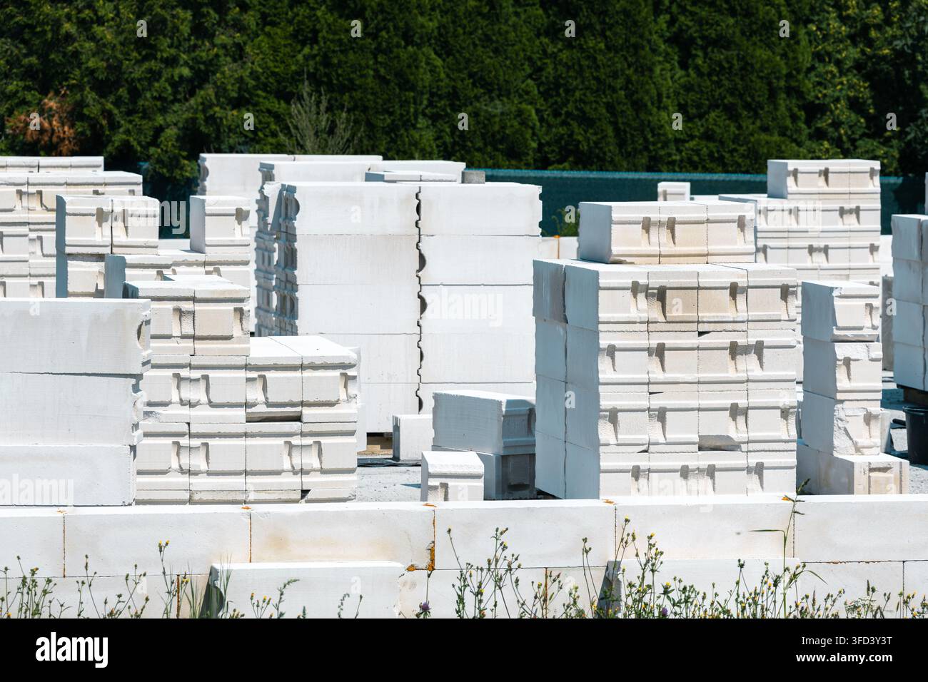 Blocchi di calcestruzzo aerato sono impilati nel cantiere edile. Il materiale viene utilizzato per le pareti delle case monofamiliari. Foto Stock