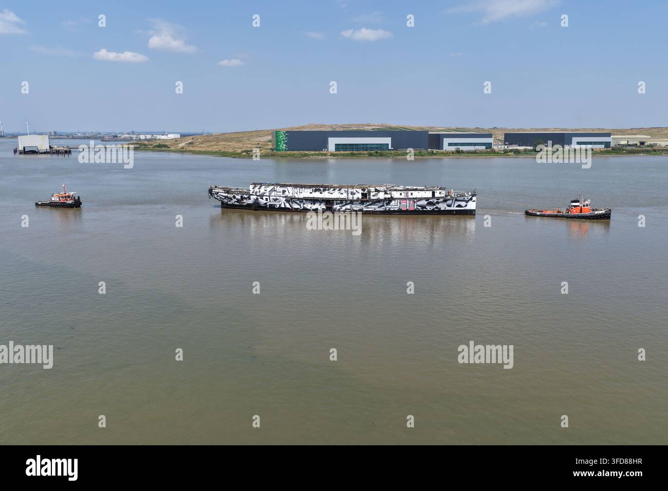 L'antica nave da guerra HMS President viene trascinata lungo il Tamigi nel suo ultimo viaggio verso il deposito di rottami di Erith, Londra, Regno Unito, il 17 luglio 2026. Foto Stock