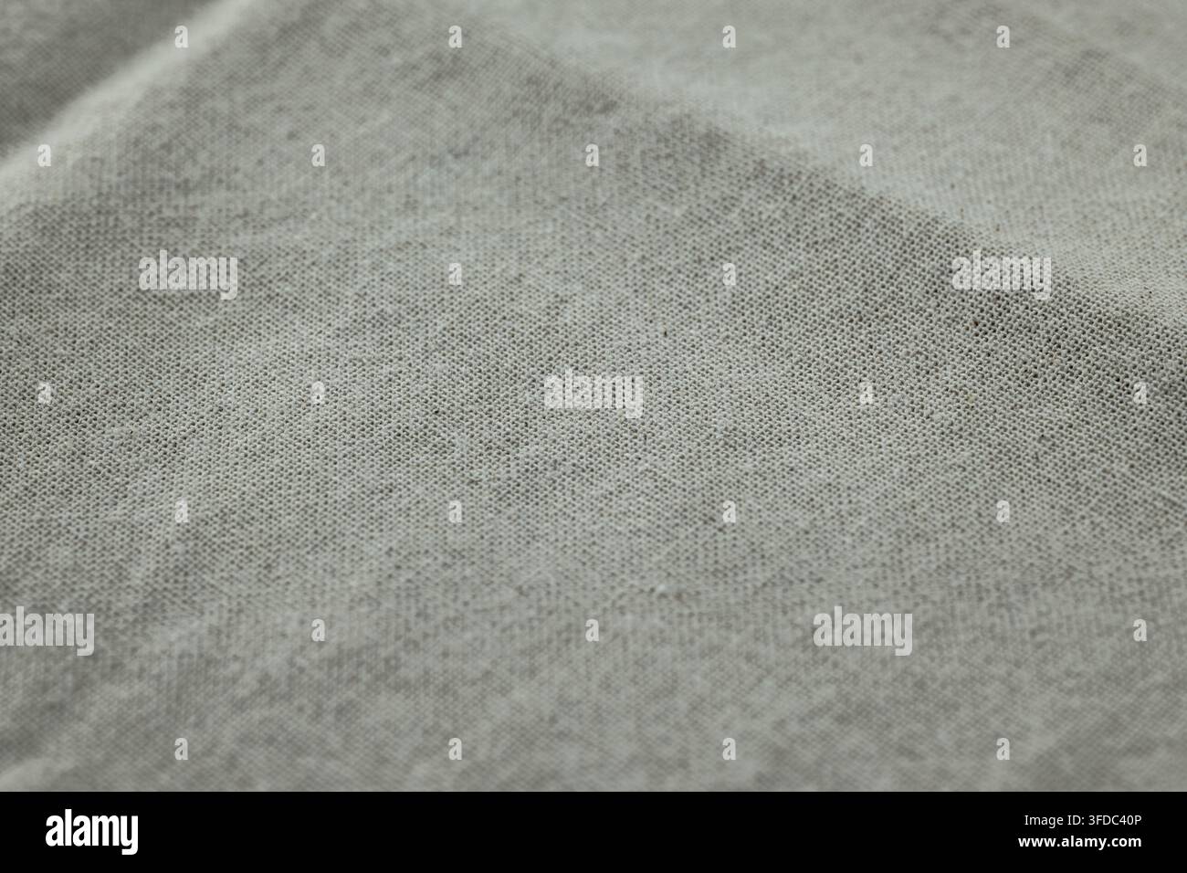 Il tessuto in jersey di cotone grigio mostra uno sfondo tessile morbido e confortevole con una trama visibile Foto Stock