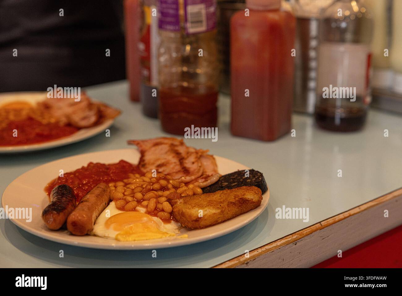 Classica colazione inglese tradizionale completa servita su un piatto in un caffè. Foto Stock