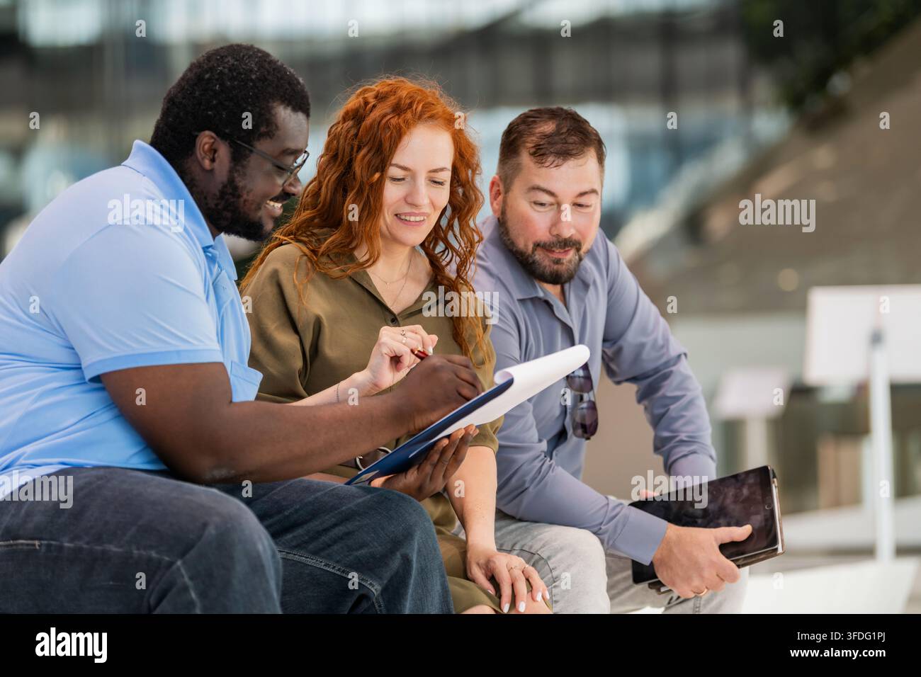Team diversificato di colleghi che collaborano all'aperto Foto Stock