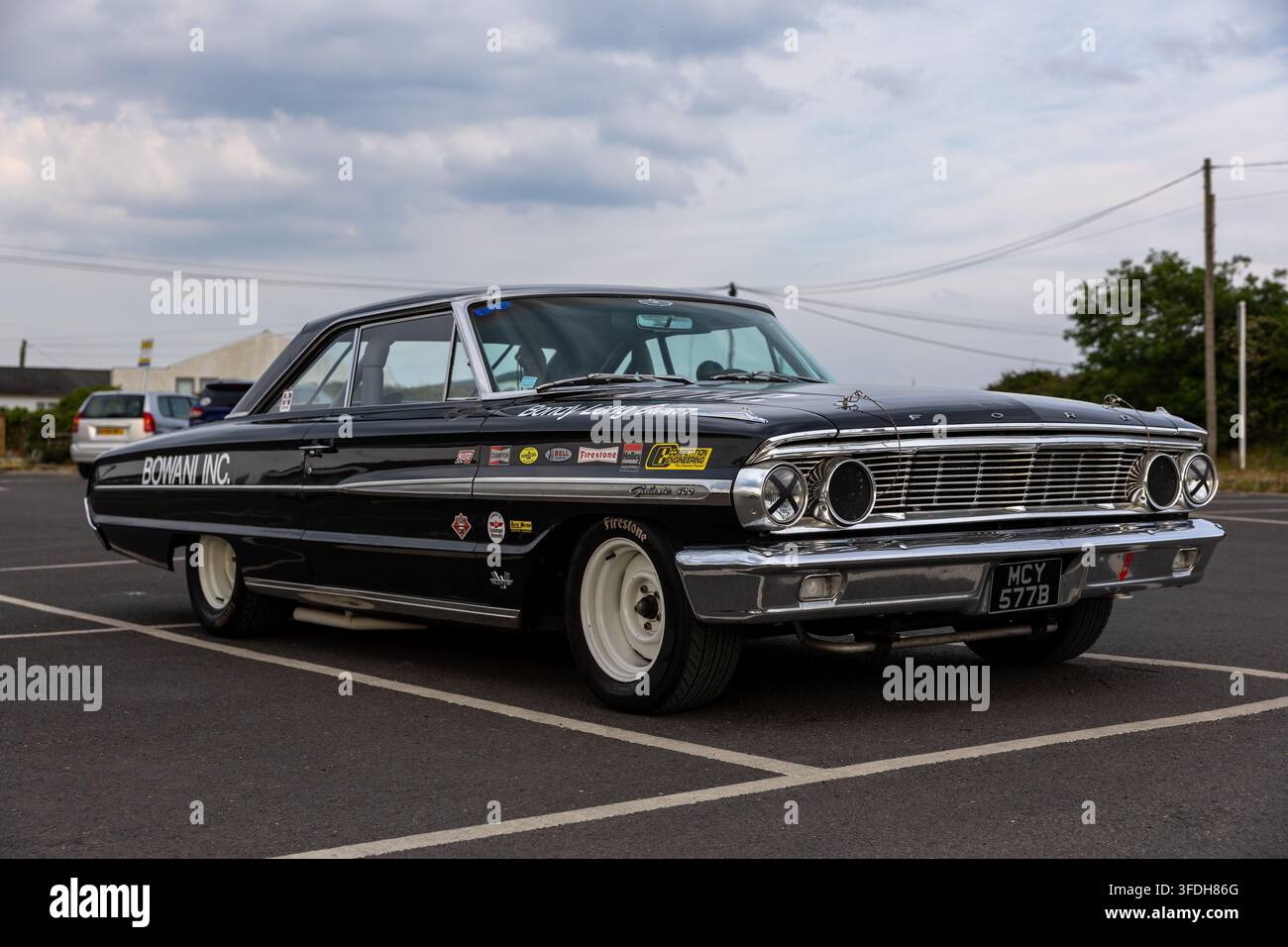 Automobile classica americana muscle nera con livrea da corsa parcheggiata all'aperto in Inghilterra Foto Stock
