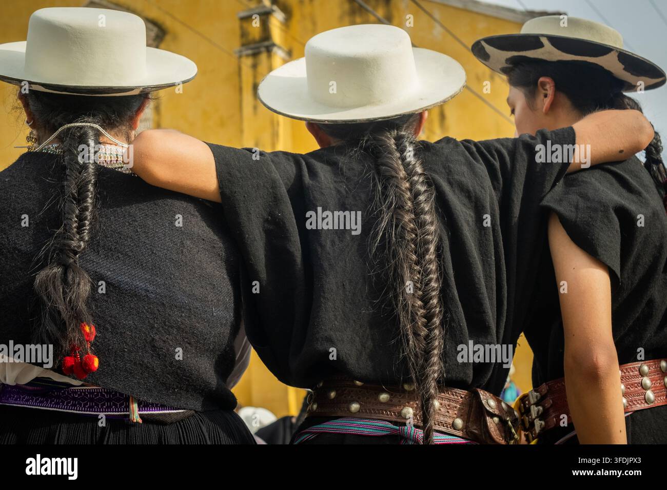 Cartagena, Bolivar, Colombia - 08 luglio 2023: Vista di tre donne con capelli intrecciati che indossano cappelli tradizionali e abiti neri in piedi insieme in fr Foto Stock