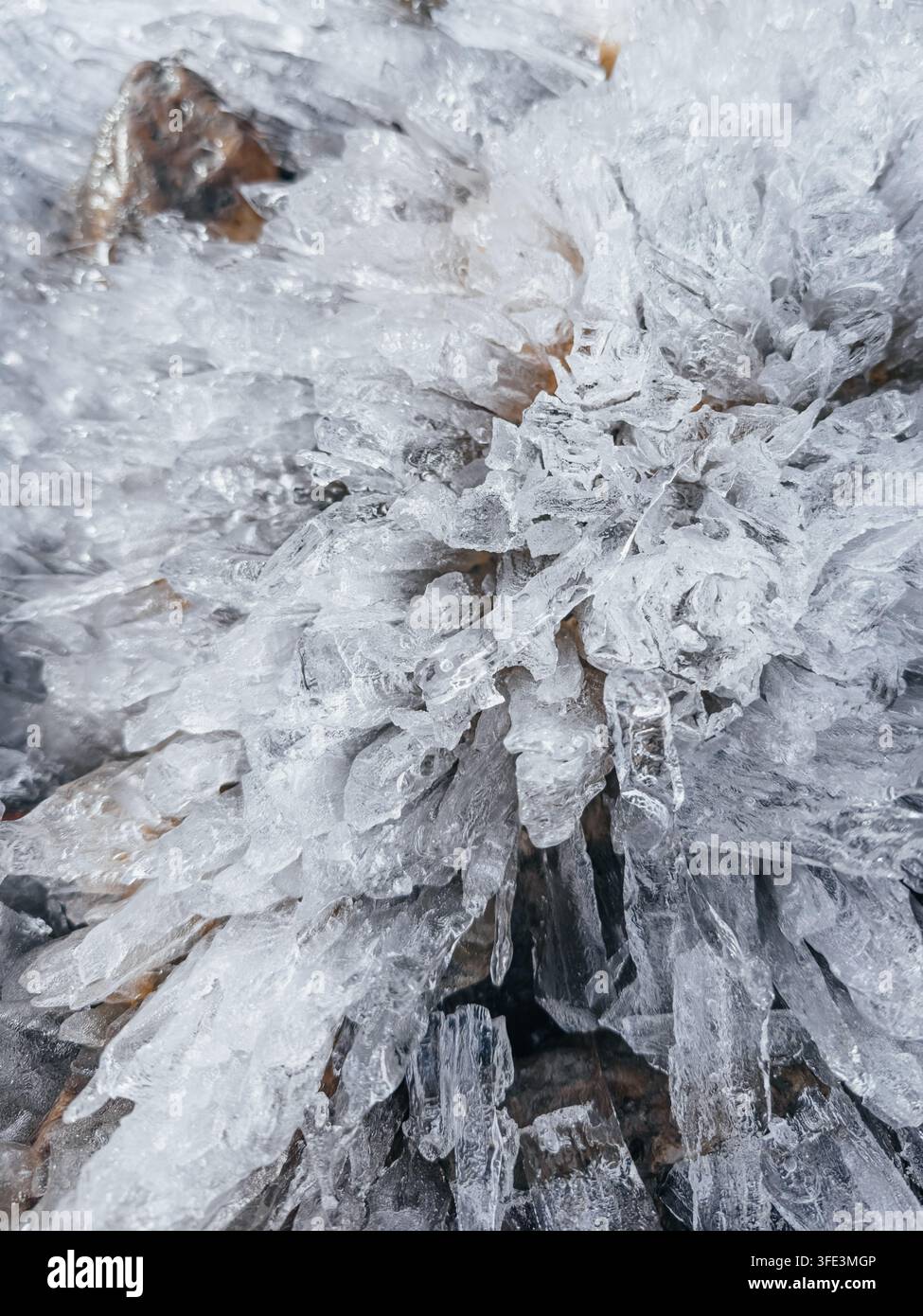Un macro primo piano di cristalli di ghiaccio affilati come aghi e schegge ghiacciate che formano uno splendido motivo geometrico Foto Stock