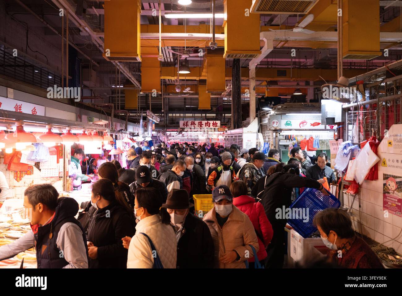 Acquirenti e venditori si affollano al Pei Ho Street Market di Sham Shui Po, Kowloon, Hong Kong, acquistando cibo fresco e carne per i pasti quotidiani. Foto Stock