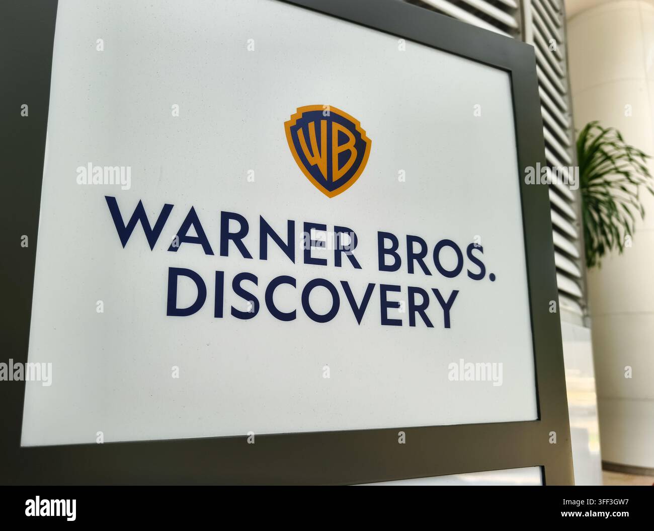 Insegna di marca per Warner Bros. Discovery, un conglomerato multinationale di media e intrattenimento Foto Stock