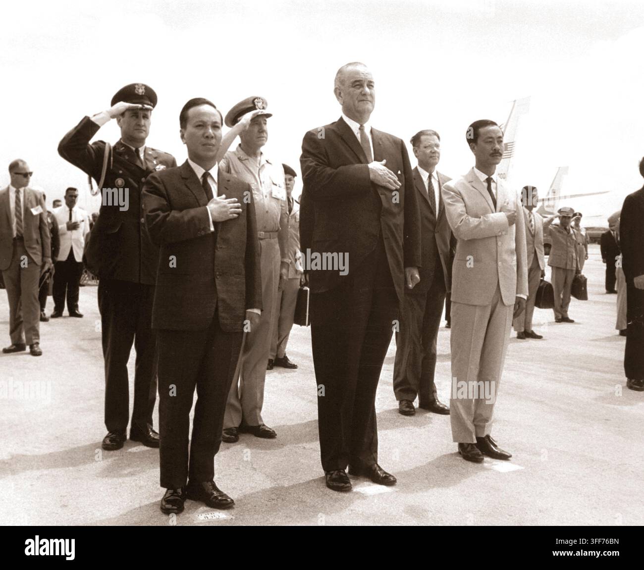Il presidente Nguyen Van Thieu, presidente Lyndon B. Johnson e il Primo Ministro Nguyen Cau Ky salute durante la riproduzione degli Stati Uniti e i vietnamiti inni nazionali nel corso di cerimonie di benvenuto a Guam's International Airport, Agana, Marzo 20, 1967. (USIA) Nara il file #: 306-SSM-8K-2 guerra & conflitto prenota #: 388 Foto Stock