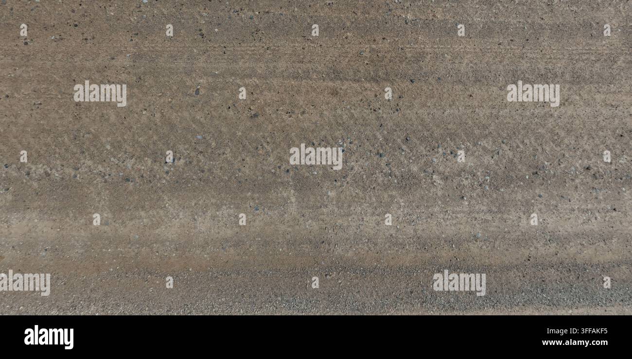 vista dall'alto sulla consistenza della strada di ghiaia tra i campi erbosi Foto Stock